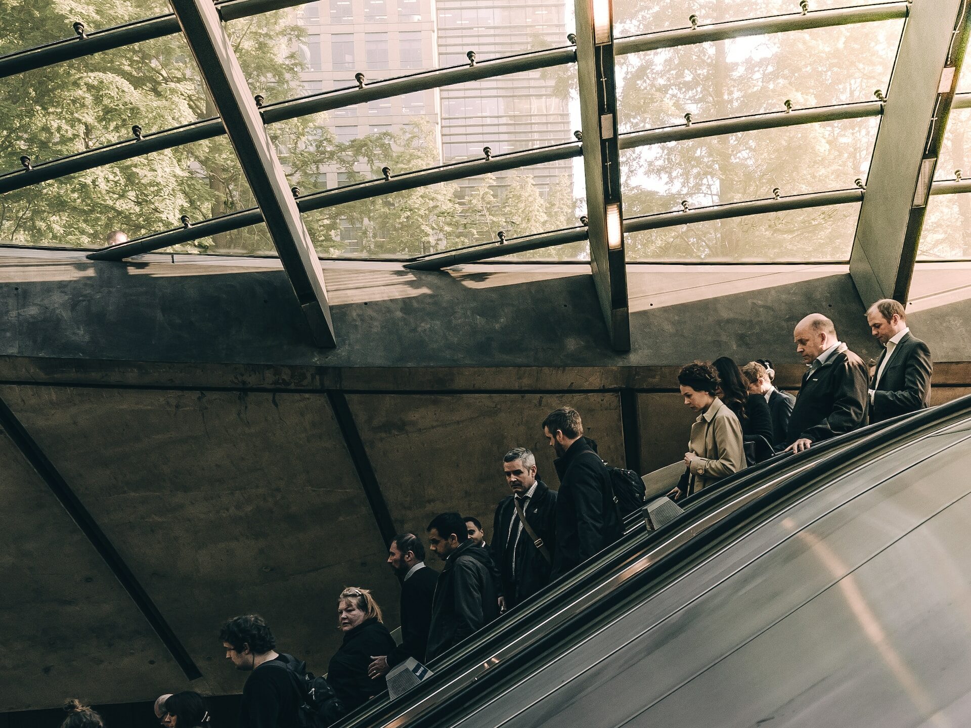 People standing on an escalator at Canary Wharf, London